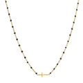 Black beaded gold cross charm stainless steel necklace on white background