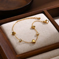 Qua 18K Gold Heart and Rhinestone Station Bracelet on jewelry display