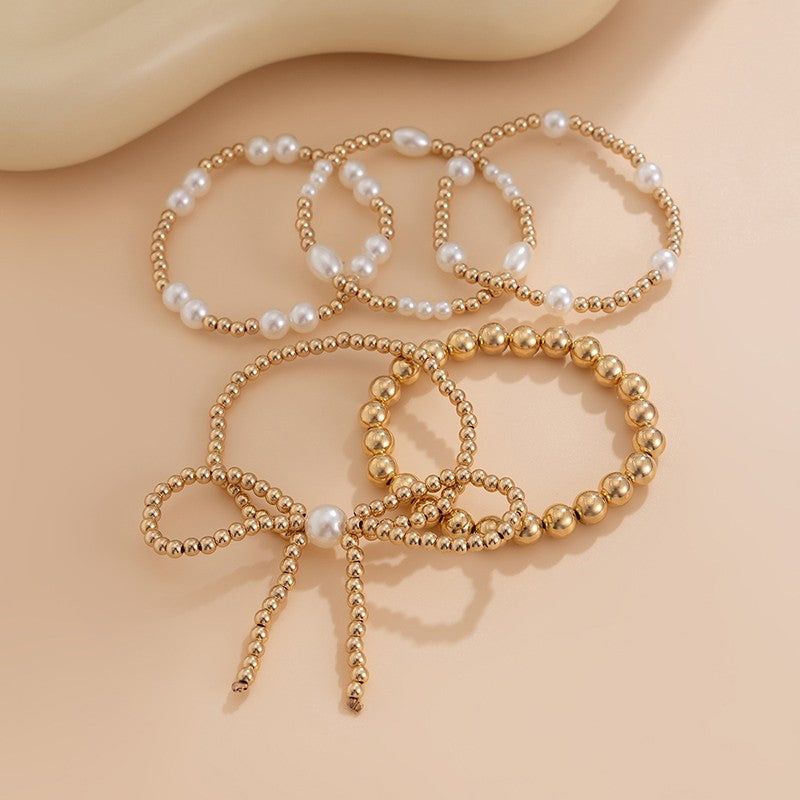 Asha Multi Layer Ball Chain Bead Pearl Bow Bracelet flat lay