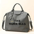 Grey Caryall The Work Bag with matching handles and trim, black lettering, and an adjustable clip-on shoulder strap