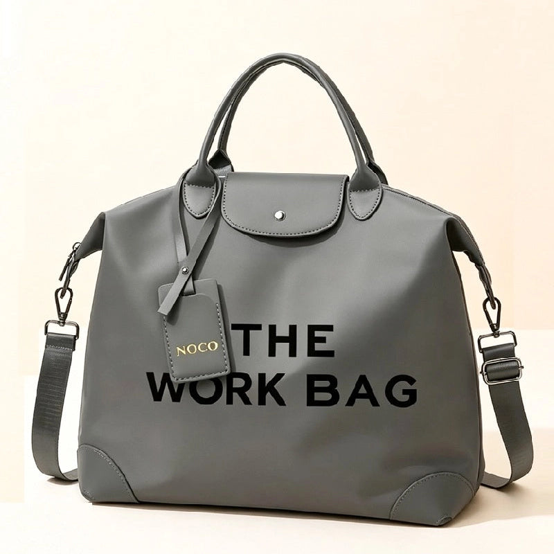 Grey Caryall The Work Bag with matching handles and trim, black lettering, and an adjustable clip-on shoulder strap