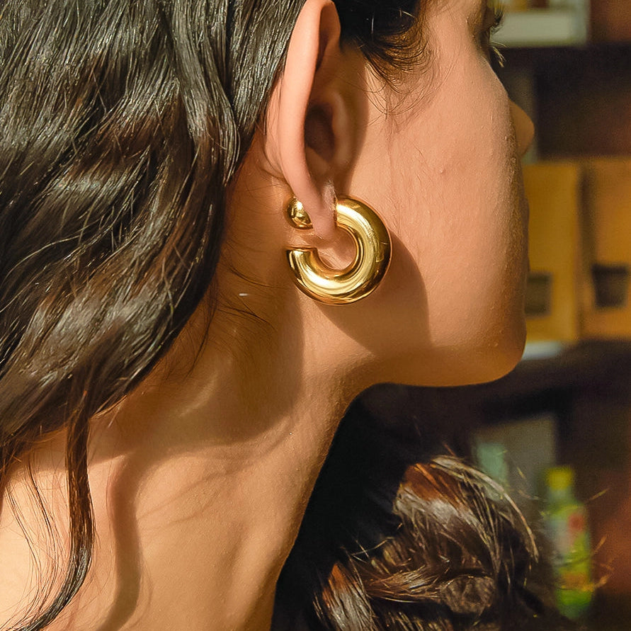 Foster 16K gold non-tarnish ball C hoop earring worn on model