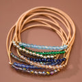 Mica Boho Blue bracelet set with gold-tone spring coil bands and shimmering blue, green, and neutral beads