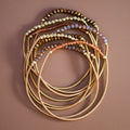 Mica Boho Brown bracelet set with gold-tone spring coil bands and shimmering brown, amber, and gold-tone beads