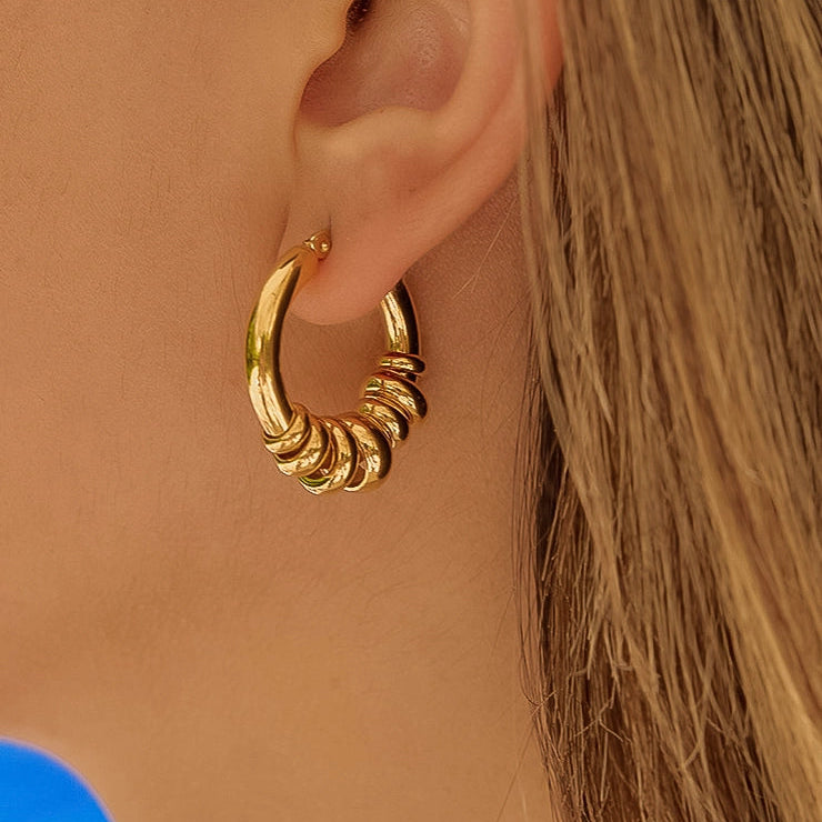 Piper Gold 18K gold non-tarnish hoop earrings worn on model