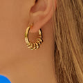 Piper Gold 18K gold non-tarnish hoop earrings worn on model
