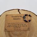 Truth Is My Identity Lapis Petrified Wood Rutilated Quartz Cross Ring with affirmation card on wood display