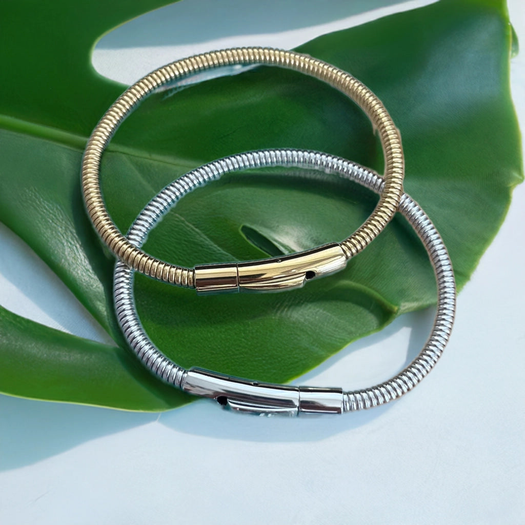 Willow Cord Bangle Bracelet in gold and silver on tropical leaf