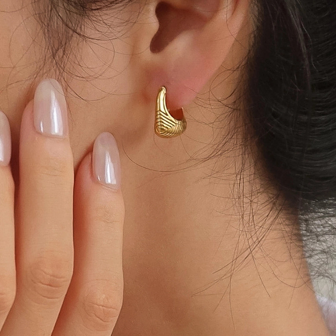 Yori Gold 18K gold non-tarnish textured hoop earrings worn on model