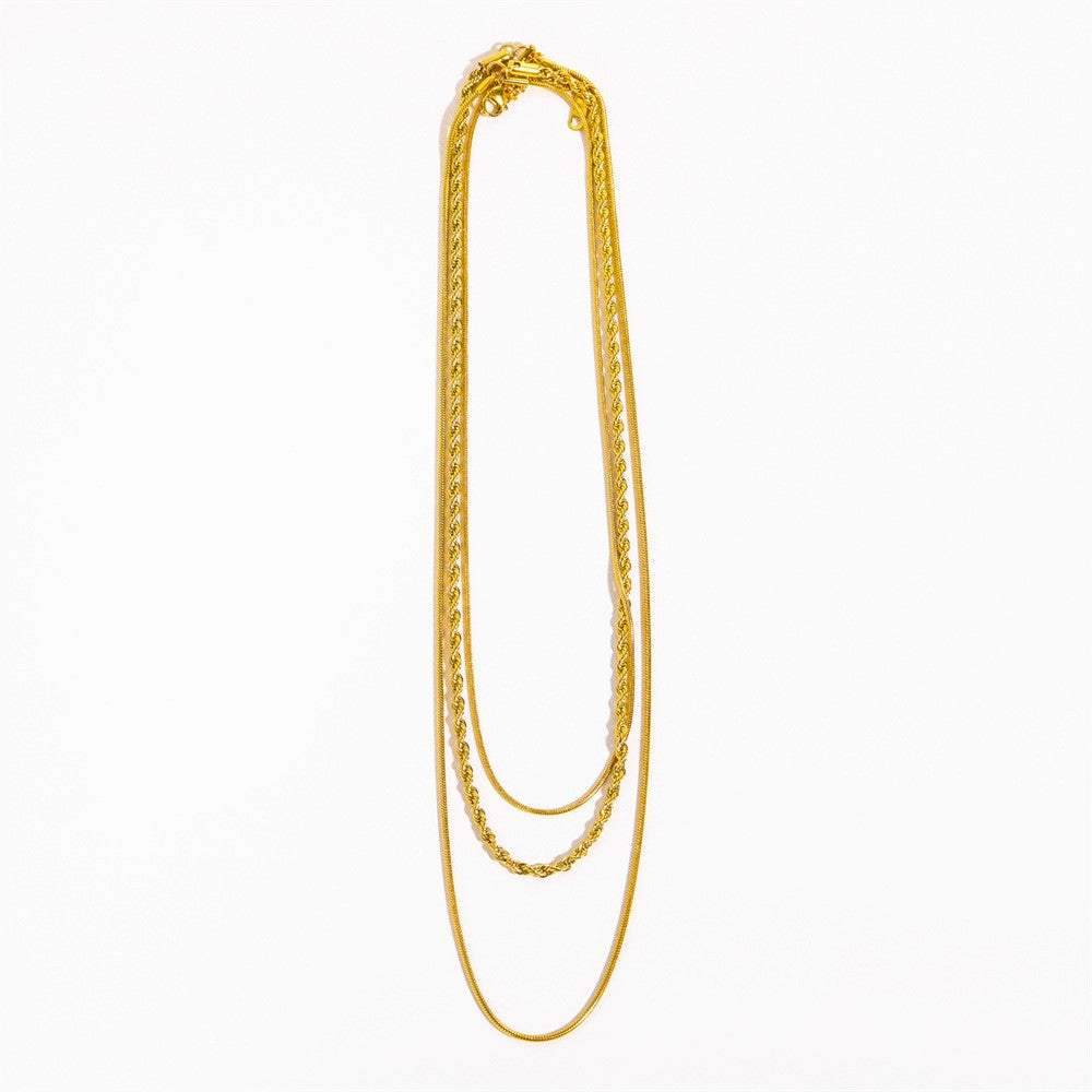 18K gold layered snake and rope chain necklace flat lay