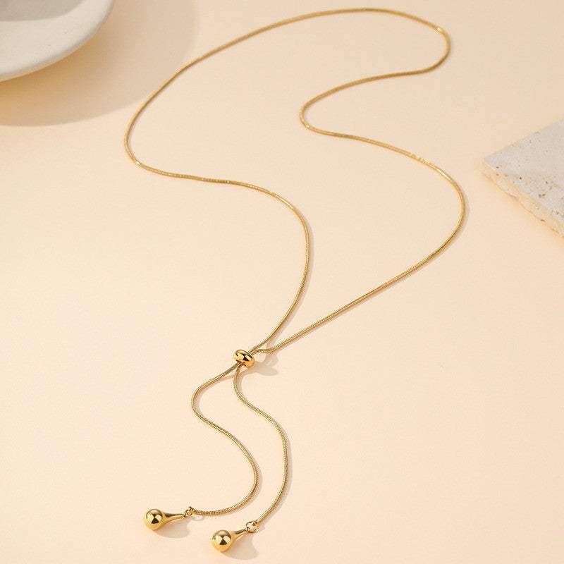 18K gold stainless steel teardrop Y necklace flat lay