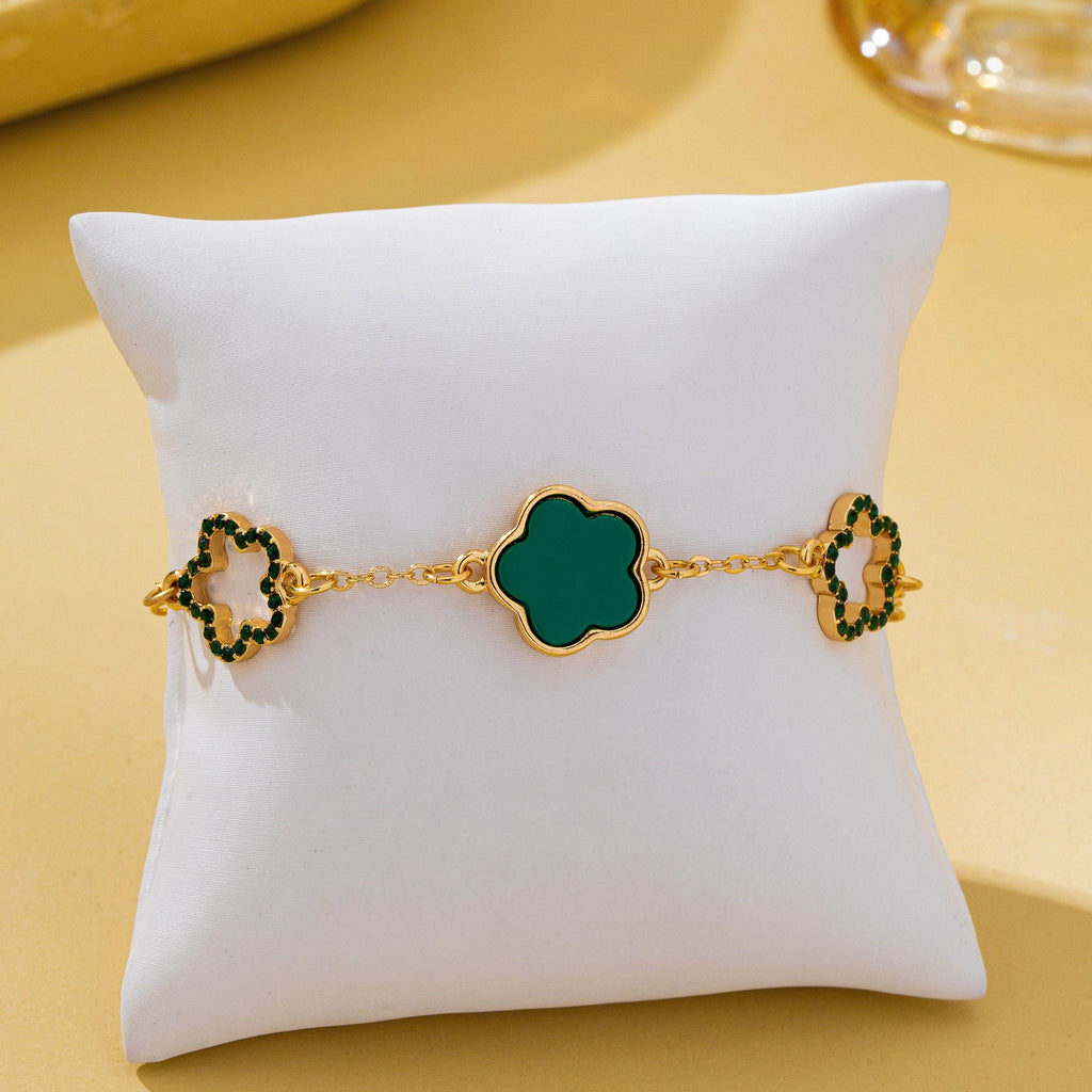 Iris Four Leaf Enamel Charm Bracelet in green on display pillow